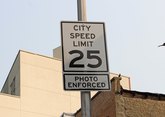 Image showing a 25 mph city speed limit sign with a photo enforced sign beneath it