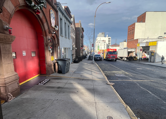 Image of a sidewalk and driveway in front of an FDNY firehouse