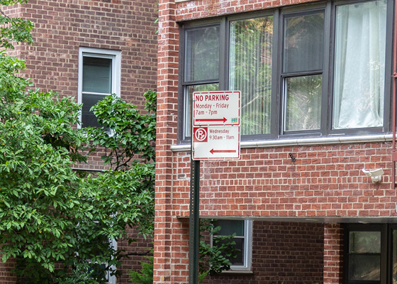 Photo of a neighborhood loading zone sign with No Parking Monday to Friday from 7am to 7pm regulations.