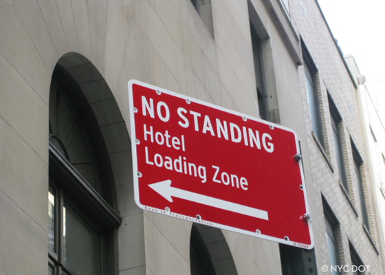 Photo of a No Standing Anytime Hotel Loading Zone sign.