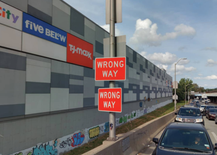 Wrong way sign mounted to a light pole.