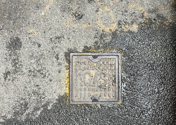 Photo of a gas shut-off valve in the roadway.