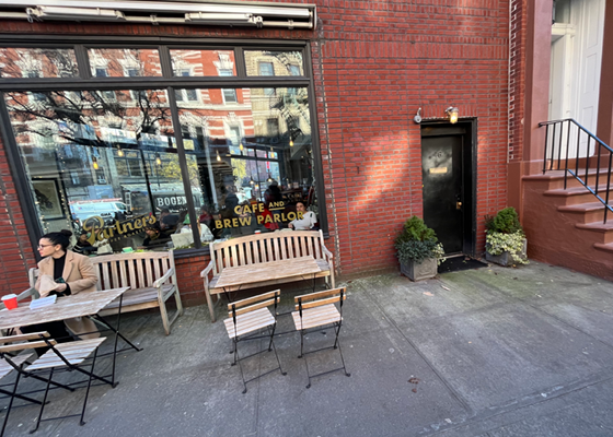 Image of a non-primary entrance adjacent to an outdoor dining area