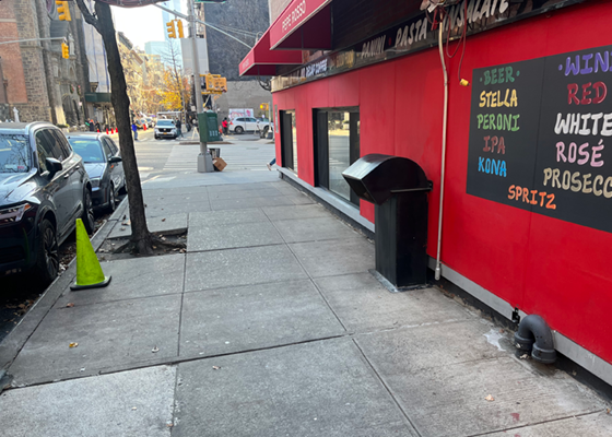 Image of an exhaust duct on a sidewalk adjacent to the building