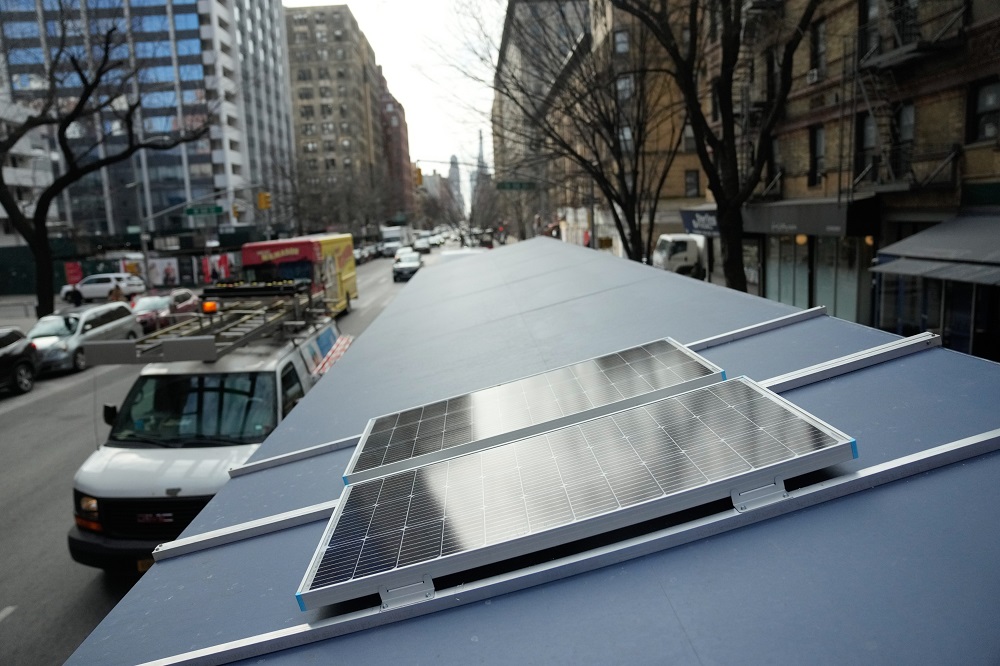 Solar panels on top of an outdoor cafe's overhead covering