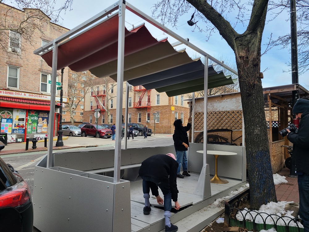 The flooring boards are placed on the base of the steep street roadway cafe in NYC