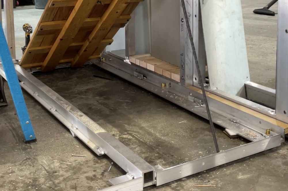 a cafe's flooring frame with a floorboard propped open inside a studio space